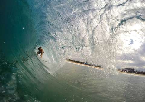 Man surfing at Arugam Bay, a famous beach in Sri Lanka