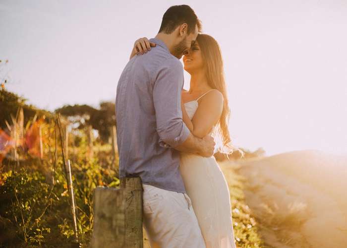 Couple sharing an intimate moment about to kiss during a honeymoon in paradise