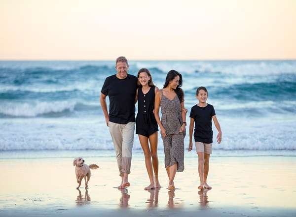 Happy family enjoying a sunny day at the beach in Sri Lanka during a multiday tour.