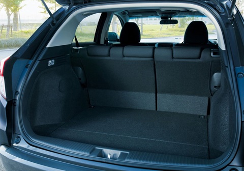 Open SUV boot loaded with travel suitcases, demonstrating large luggage capacity.