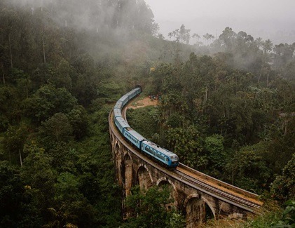 Blue train crossing Nine Arch Bridge in Ella’s scenic hill country
