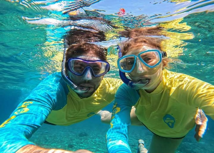 Couple snorkeling together in the ocean in Trincomalee, Sri Lanka