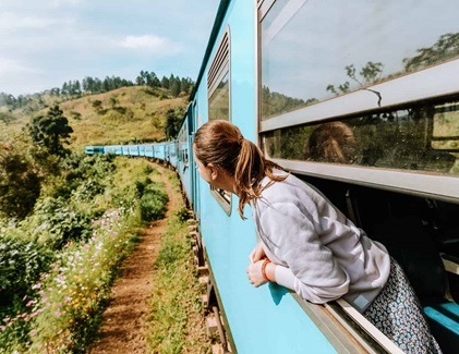 Woman enjoying the scenic train ride through Sri Lanka’s hill country