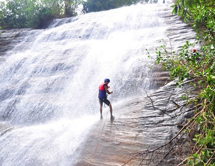 Adventurer abseiling down a waterfall near Kitulgala in Sri Lanka
