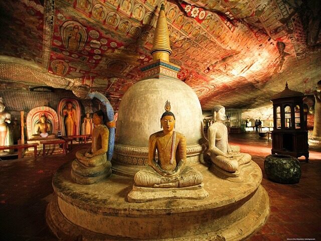 Interior of Dambulla Cave Temple with Buddha statues and murals