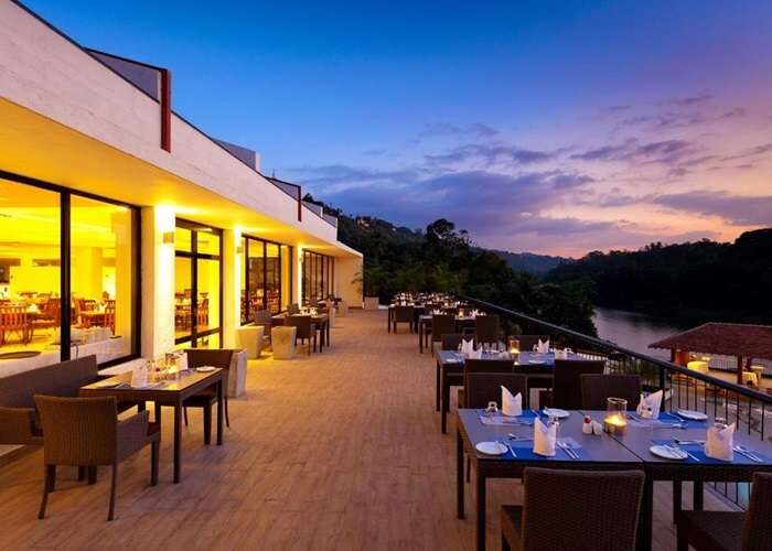 Evening balcony dining area with tables and chairs at Cinnamon Citadel Sri Lanka