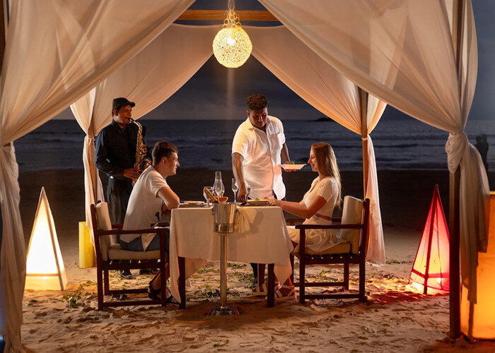 Candle-light dinner setup on the beach at night at EKHO Surf Bentota