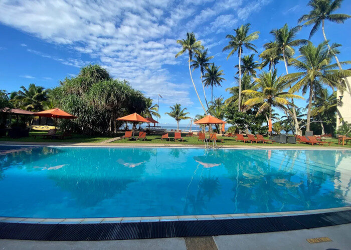 Mandara Resort Mirissa pool and beach view under bright blue sky