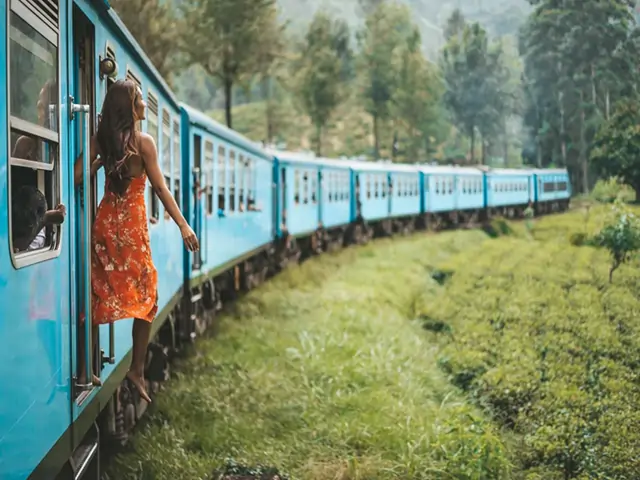 Scenic train ride in Ella, Sri Lanka, with stunning views of lush green landscapes, tea plantations, and misty mountains.