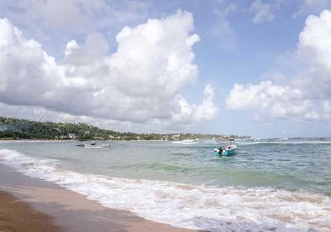 Beautiful shoreline and blue waters at Unawatuna Beach
