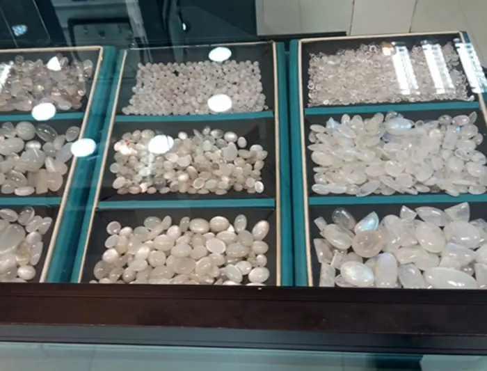 Traditional moonstone mining pit and workers at Meetiyagoda Sri Lanka