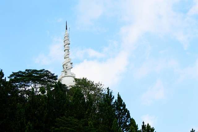 Ambuluwawa Tower partially visible through lush green trees in Sri Lanka