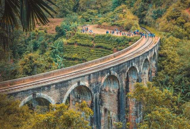 Nine Arches Bridge in Ella surrounded by lush green hills in Sri Lanka
