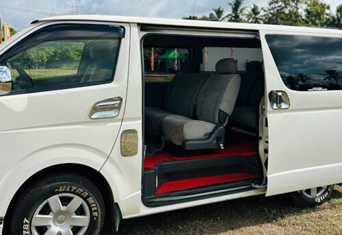 Outside view of KDH flat roof van with side door open.